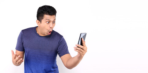 Shock and surprise face of Asian man presenting smart phone on white background in studio With copy space