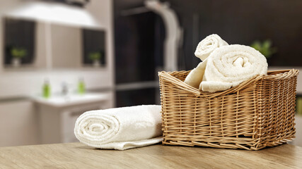 Fototapeta na wymiar Towels on desk and bathroom interior 