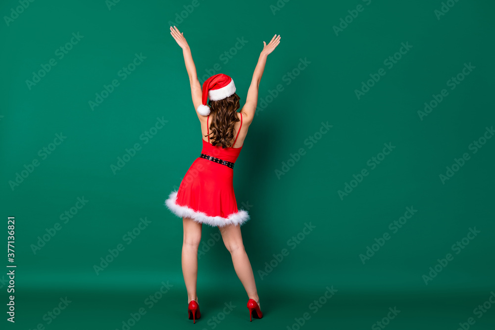 Wall mural Full length rear behind back view photo of charming lady good mood raise arms rejoicing newyear party chilling night club wear x-mas snow girl costume isolated green color background