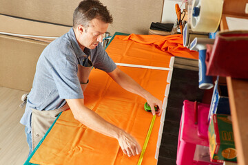 Qualified workman upholstering furniture in repair furniture