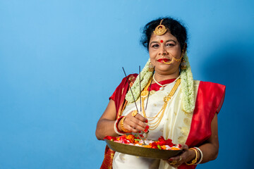 Indian Woman holding plate of religious offering , Durga Puja and Diwali Concept with Bengali woman.