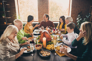 Portrait of nice attractive cheerful cheery positive glad family parents grandparents eating harvest tradition celebratory festive autumn fall at modern loft industrial brick interior house
