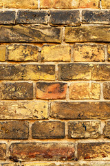 vintage brick wall in yellow. yellow brick wall texture for background, vertical image..