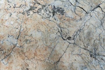 Surface of the marble with black lines and cracks. beige Cracked Marble rock stone background