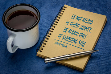 happy thoughts inspirational handwriting on a small sheet of white Khadi rag paper against colorful abstract landscape, positive mindset concept