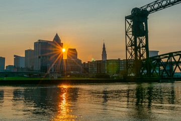 Sunrise over city on river near water