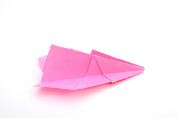 A pink paper airplane on white background with clipping path