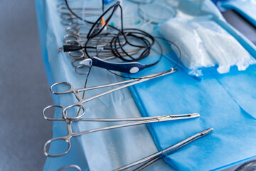 Surgical instruments arranged on a sterile field. Tools in the operating room. Closeup.