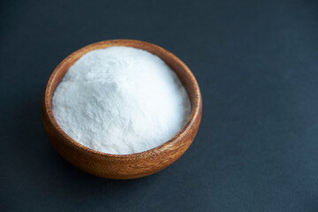 Glass bowl of baking soda. Spoonful of bicarbonate.