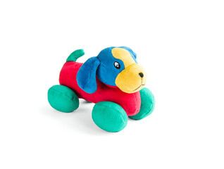 Dog plush doll isolated on white background with shadow reflection. The dog plush doll on a white background. Colorful plush toy. Colored soft toy-dog. Green, red, blue dog