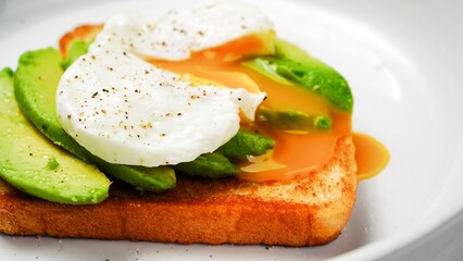 Poached egg avocado toast breakfast on white background overhead view