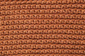 Brown knitted fabric texture background. Top view. Copy, empty space for text