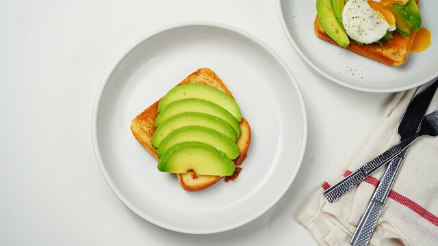 Poached Egg Avocado Toast Breakfast On White Background Overhead View