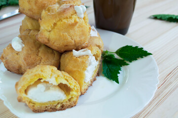 Custard cookies and coffee with milk, eclair