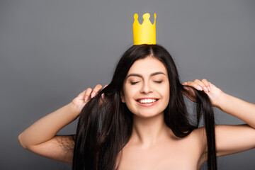 naked brunette long haired woman in crown smiling isolated on black