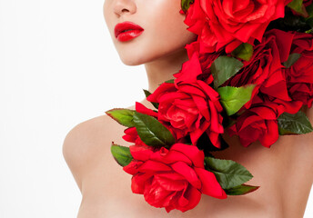 Beautiful woman face surrounded by red roses. Perfect skin. Professional makeup.