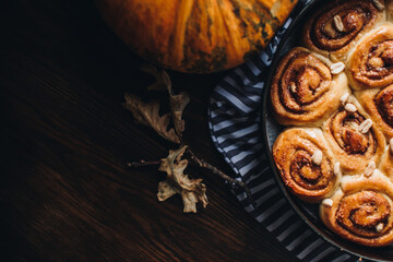 Pumpkin cinnamon bun rolls. Bakery for the Thanksgiving party. Cozy autumn or winter still life details. 