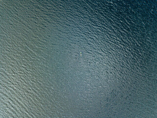 Aerial drone view. Fishing boat on the waves of the river.