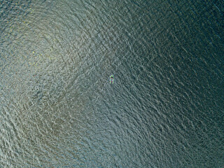 Fototapeta na wymiar Aerial drone view. Fishing boat on the waves of the river.