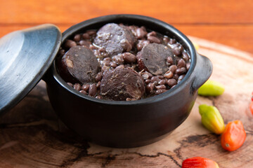 Feijoada. Traditional Brazilian food. Wood background.
