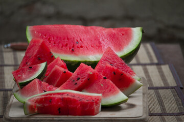 Fresh red watermelon on wooden cutting board, picnic concept, selective focus