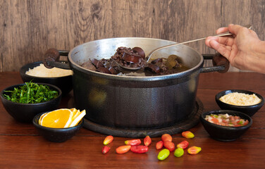 Feijoada. Traditional Brazilian food. Wood background.