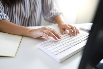 Naklejka premium Hands typing on keyboard. writing a blog. woman hands on the keyboard Working at home