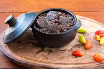 Feijoada. Traditional Brazilian food. Wood background.