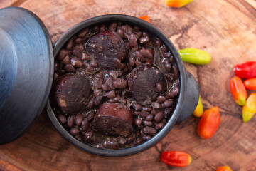 Feijoada. Traditional Brazilian food. Wood background. Top view.