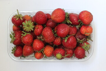 strawberries in a bowl on white background