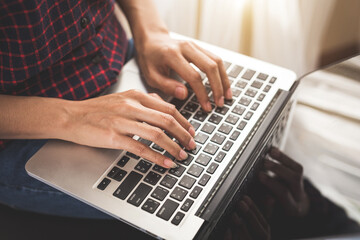 Fototapeta na wymiar Woman's hand typing on laptop keyboard computer 