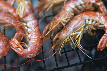 Large Argentine shrimp. Cooking at the stake. Grilled food. Natural conditions. Seafood. Bonfire.