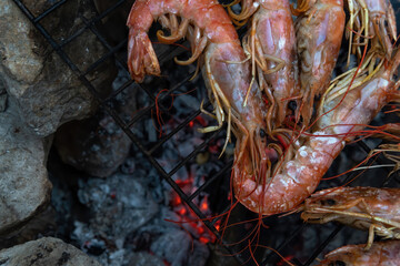 Large Argentine shrimp. Cooking at the stake. Grilled food. Natural conditions. Seafood. Bonfire. Place for text. Copy space