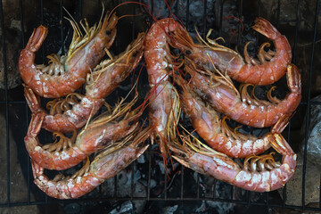 Large Argentine shrimp. Cooking at the stake. Grilled food. Natural conditions. Seafood. Bonfire.