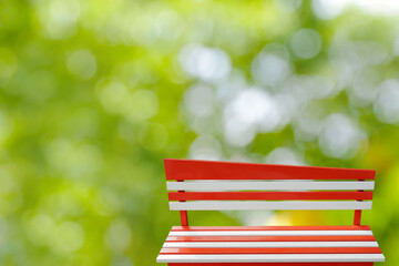 Colorful benches painted red and white with metal legs present a natural background decoration ,...