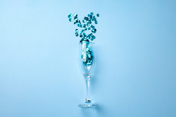 Champagne glass with confetti flat lay top view