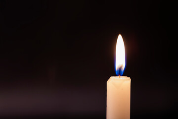 One candle flame at night close - up-macro.