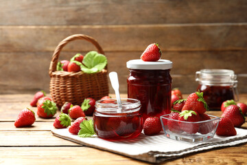 Delicious pickled strawberry jam and fresh berries on wooden table