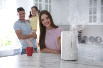 Family in kitchen with modern air humidifier