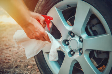 Close up of man's hands with spray bottle and towel
