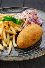 Kiev cutlet with american fries and red cabbage with carrot