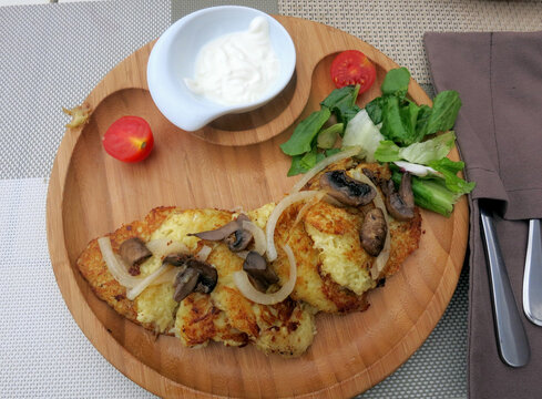 potatoes pancaces served on wood dish.