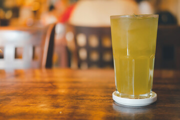 Iced green tea in glass on wood table