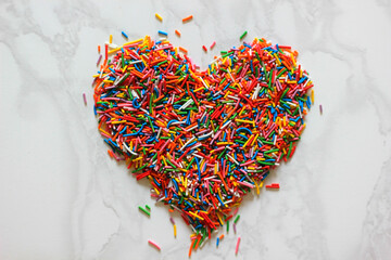 multi-colored pastry topping in the shape of a heart, mother day, valentines day, horizontal, background, sweet heart, symbol love, selective focus, defocusing