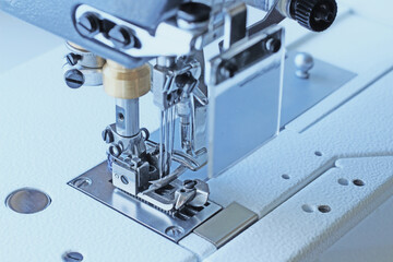 Industrial flat-seam sewing machine. Close-up. Soft focus