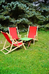 wooden deckchair in red color - relax, rest in the fresh air