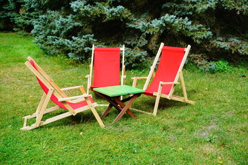 wooden deckchair in red color - relax, rest in the fresh air