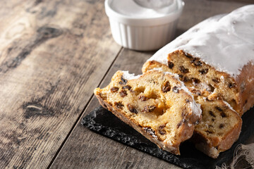 Christmas stollen fruit cake on wooden table.	Copy space