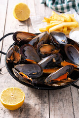 Moussels and french fries or molues-frites. Typical Belgian food. 	