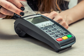 Credit or debit card password payment. Customer hand is entering personal identification number in...